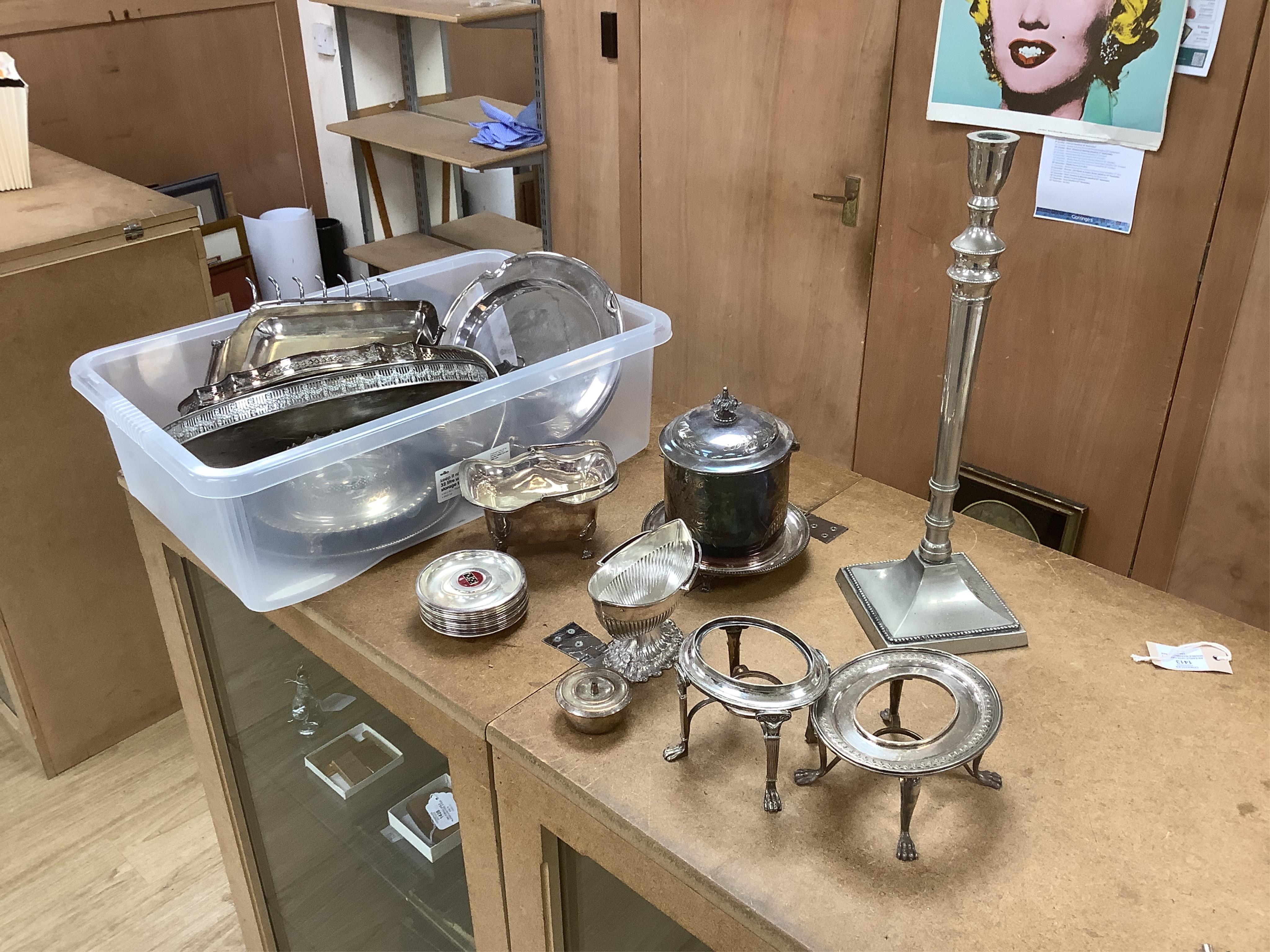 Two boxes of plated ware including a tall candlestick, a two handled tray and two galleried trays. Condition - fair